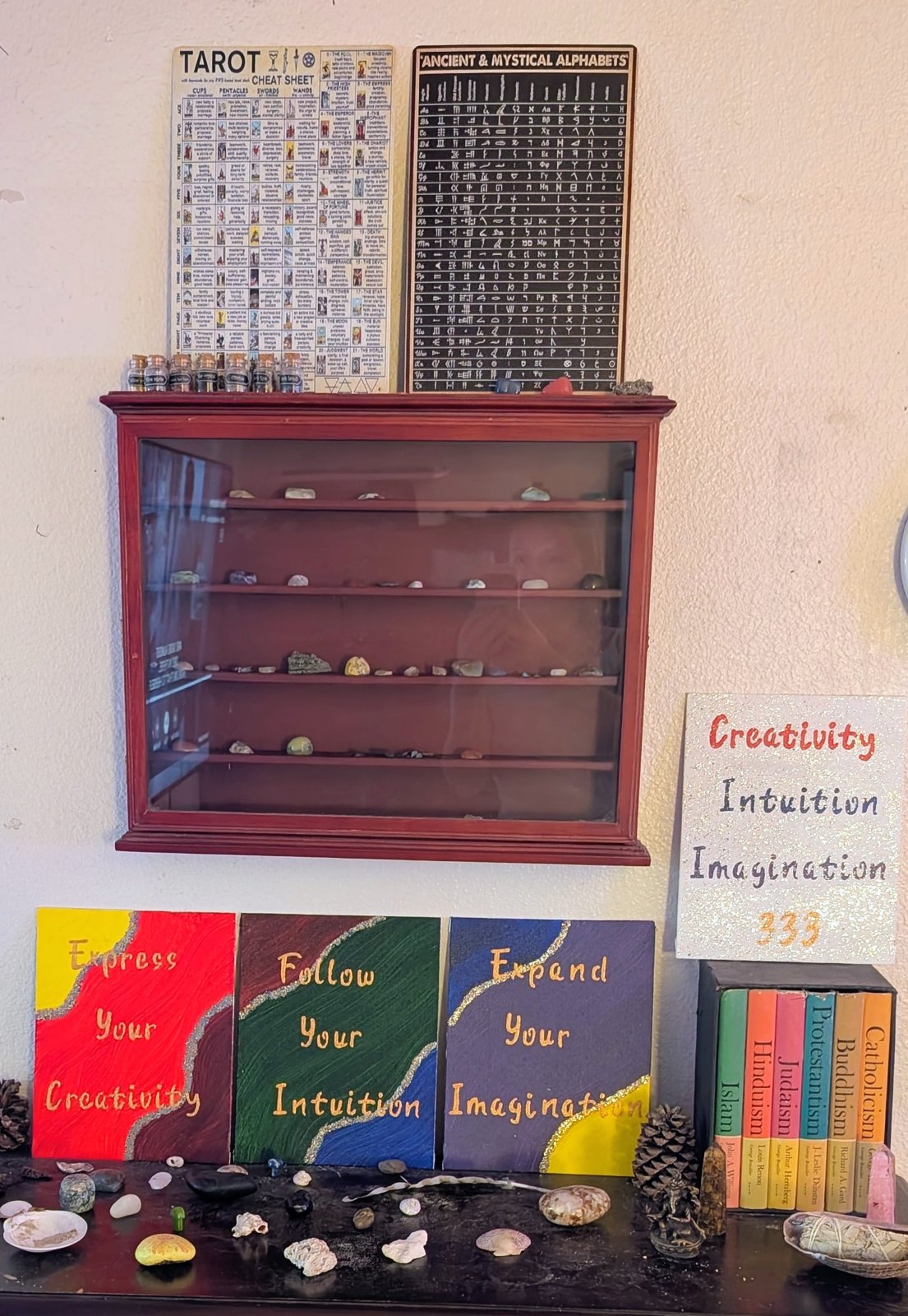 Inspirational word canvases arranged beneath a display shelf