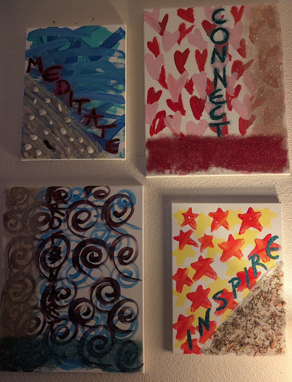 Four small canvases with the words meditate, connect and inspire
